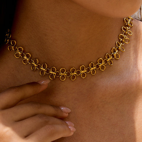 An elegant side profile of a model wearing The Elodie Choker, which adds a subtle, sophisticated touch of gold to her look.