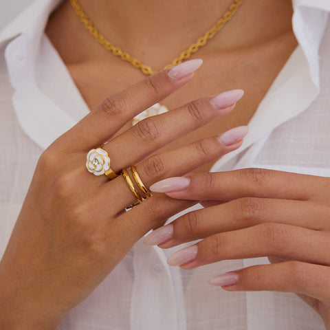 A model showcasing a coordinated look, wearing The Fleur Ring and the matching Fleur Pendant necklace for a touch of classic elegance.