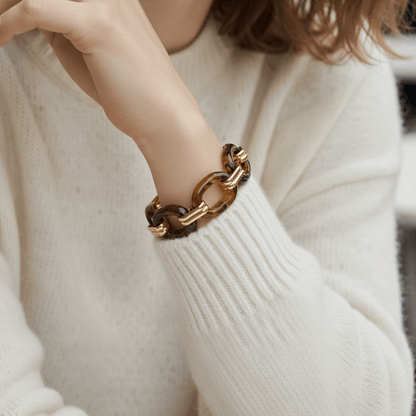 The Florence Link Bracelet worn by a model in a cozy white sweater, proving it's the perfect statement piece to instantly elevate a simple, everyday look.