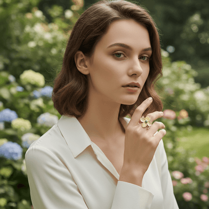 A model's hand, adorned with the bold Gaia Ring, resting on her fringed suede bag or a macramé wall hanging. This image perfectly captures the quintessential bohemian aesthetic, connecting the ring to textures of the boho lifestyle