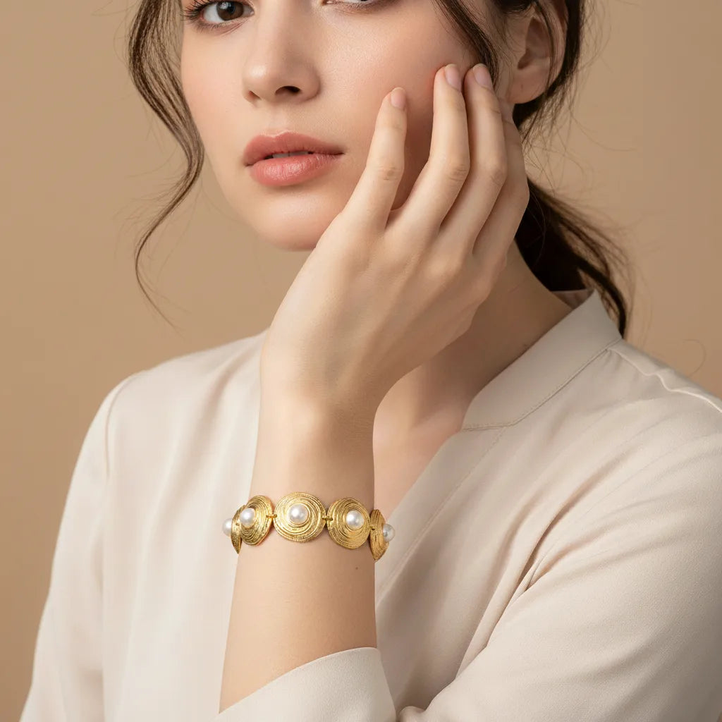 A close-up of The Hera Bracelet worn on a model's wrist, with her hand elegantly raised, showcasing the piece's bold scale and beautiful craftsmanship.