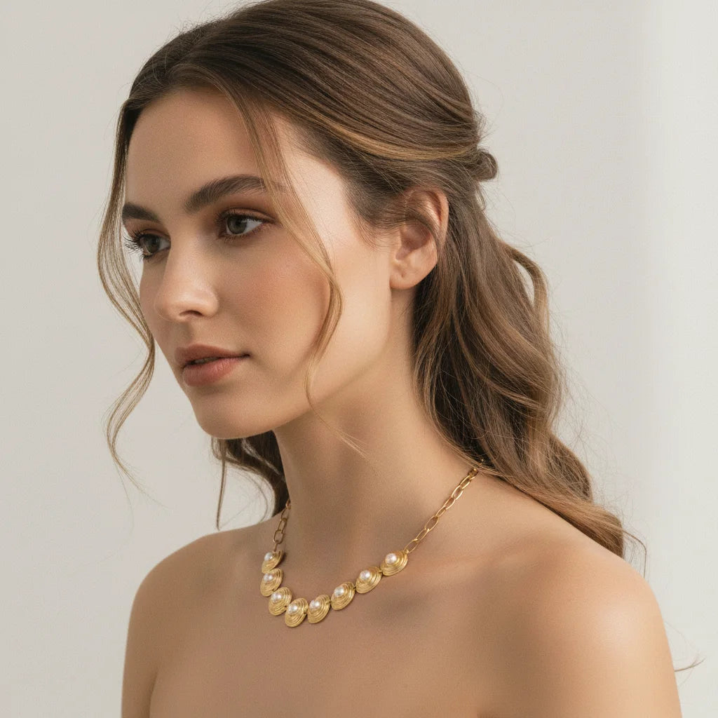 Side profile of a model with an elegant updo, wearing The Hera Necklace to showcase its beautiful curve and intricate details from another angle.