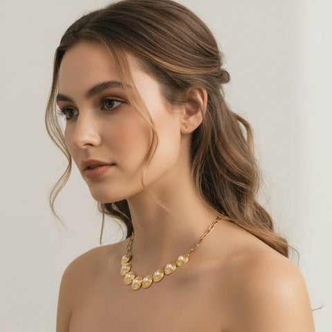 Side profile of a model with an elegant updo, wearing The Hera Necklace to showcase its beautiful curve and intricate details from another angle.