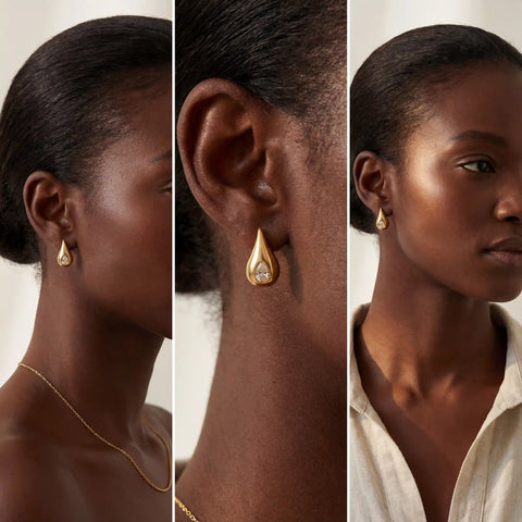 Dark skin model styling gold teardrop earrings with crystal accent vintage modern vibe.