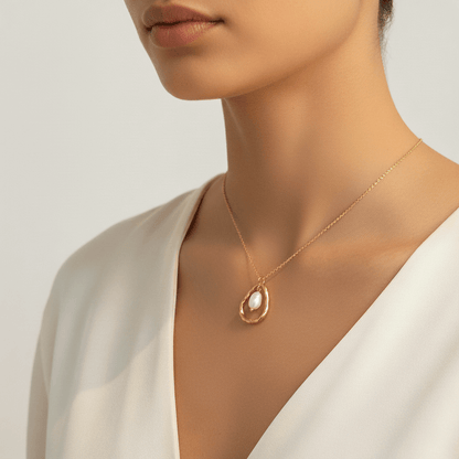 A model in a crisp white shirt, with the delicate Luna Pearl necklace adding a touch of sophisticated, minimalist charm to her professional attire.