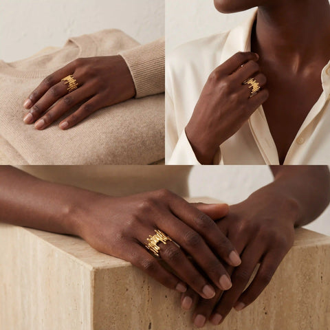Fashion styling of Midas gold statement ring on black woman elegant look.