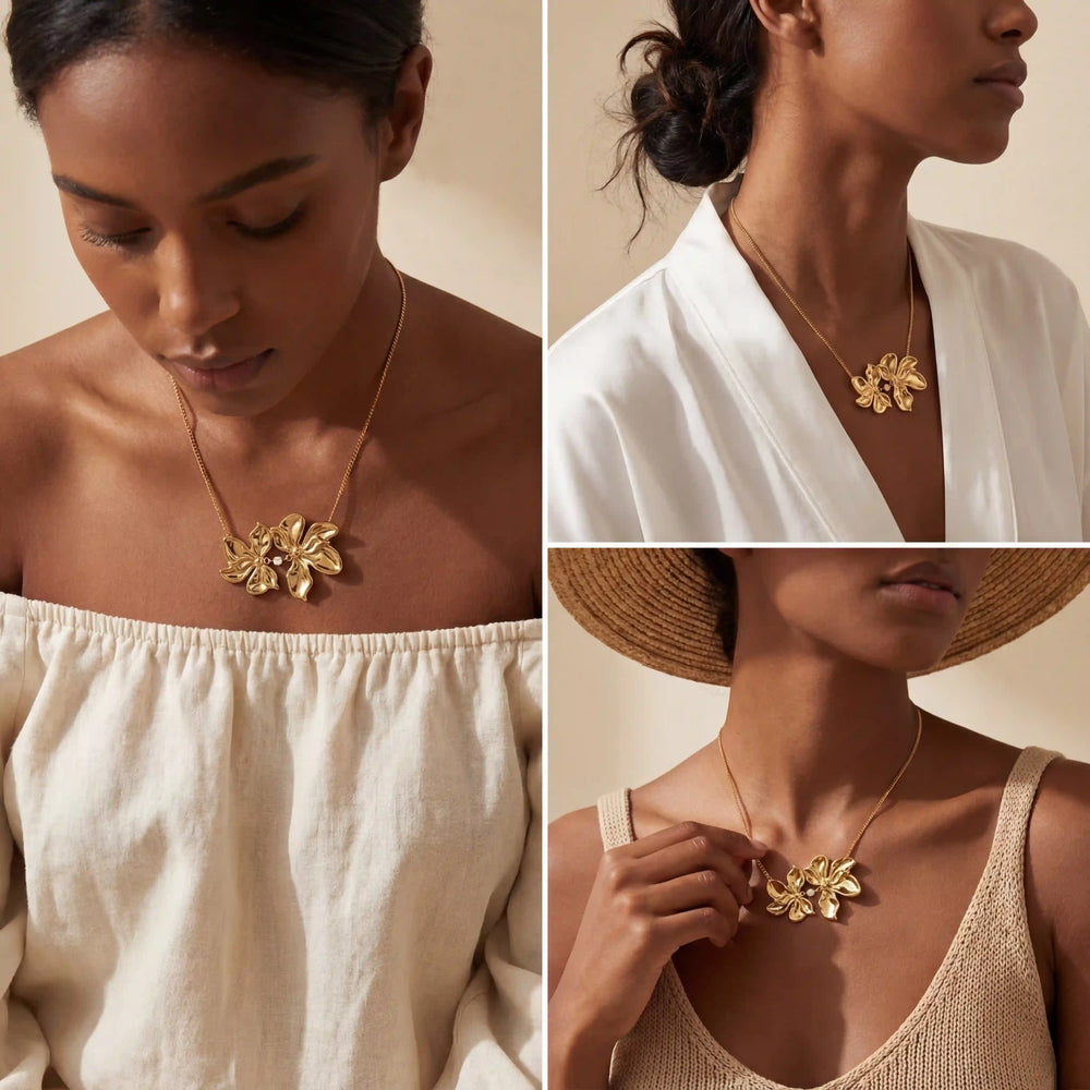 Model with dark skin styling gold floral pendant necklace with white off-shoulder top boho vibe.