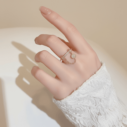 The Comet Ring lying on a vintage star chart or a piece of dark blue paper sprinkled with gold dust. This creative flat-lay directly connects the ring's design to its celestial, astronomical inspiration.