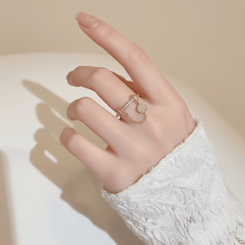 The Comet Ring lying on a vintage star chart or a piece of dark blue paper sprinkled with gold dust. This creative flat-lay directly connects the ring's design to its celestial, astronomical inspiration.