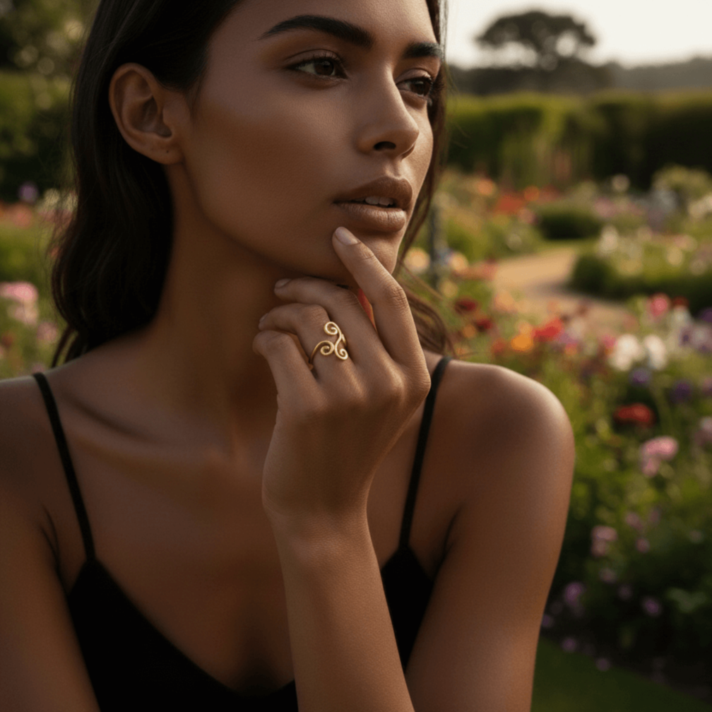 A model's hand, adorned with the whimsical Aphrodite Ring, resting on the cover of an old, leather-bound book. The scene creates a storybook, fairytale atmosphere, perfect for the ring's enchanting design.