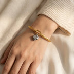 Model wearing twisted cable heart bangle aesthetic beige background lifestyle video.