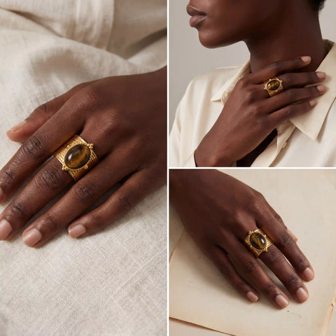 Fashion styling of vintage gold statement jewelry on black woman wearing white shirt.