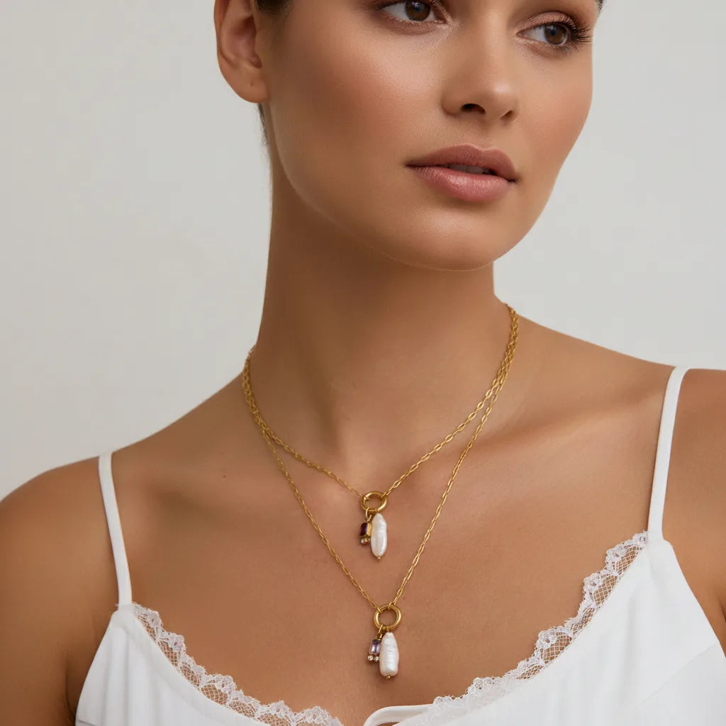 A close-up of a model wearing The Astoria Necklace with a simple white camisole, illustrating its delicate and personal feel for everyday wear.