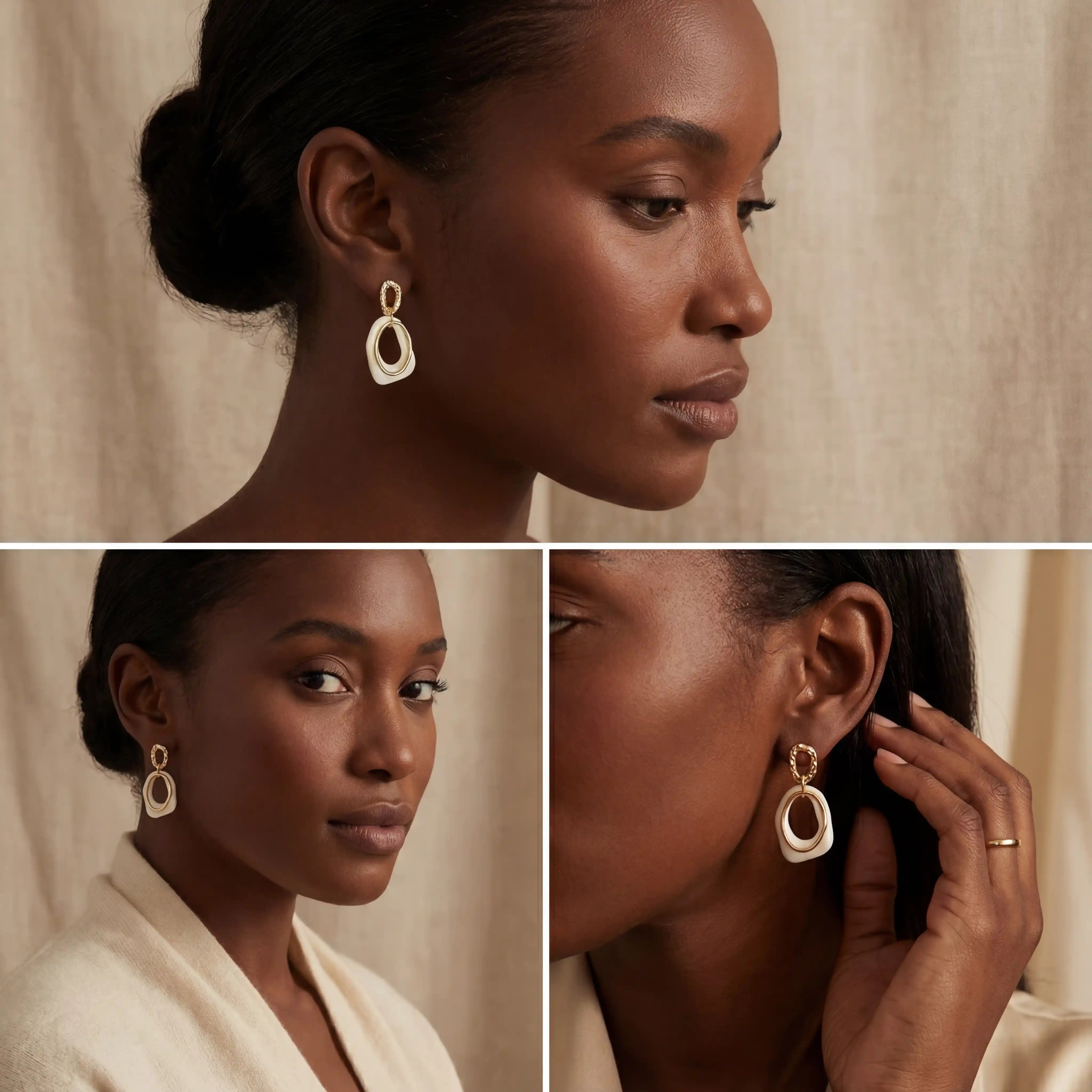 Black woman wearing cream enamel gold earrings showing contrast styling on dark skin.