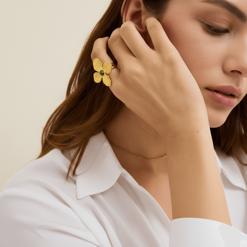 A model's hands are visible, with the Gaia Ring on one hand, complemented by several delicate, thin gold stacking rings and beaded bracelets, demonstrating a chic, layered boho look