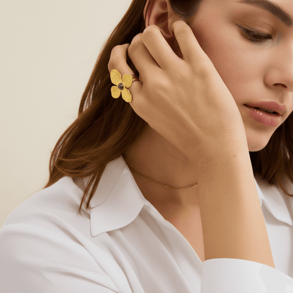 A model's hands are visible, with the Gaia Ring on one hand, complemented by several delicate, thin gold stacking rings and beaded bracelets, demonstrating a chic, layered boho look